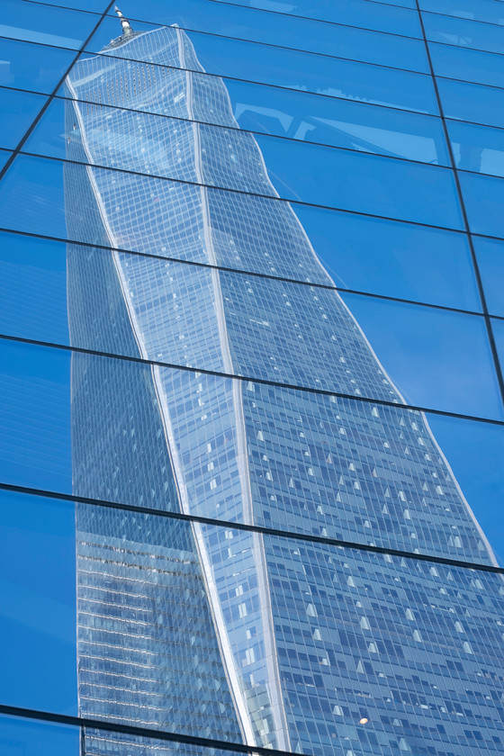 One World Trade Center reflected in 9 11 Museum Glass